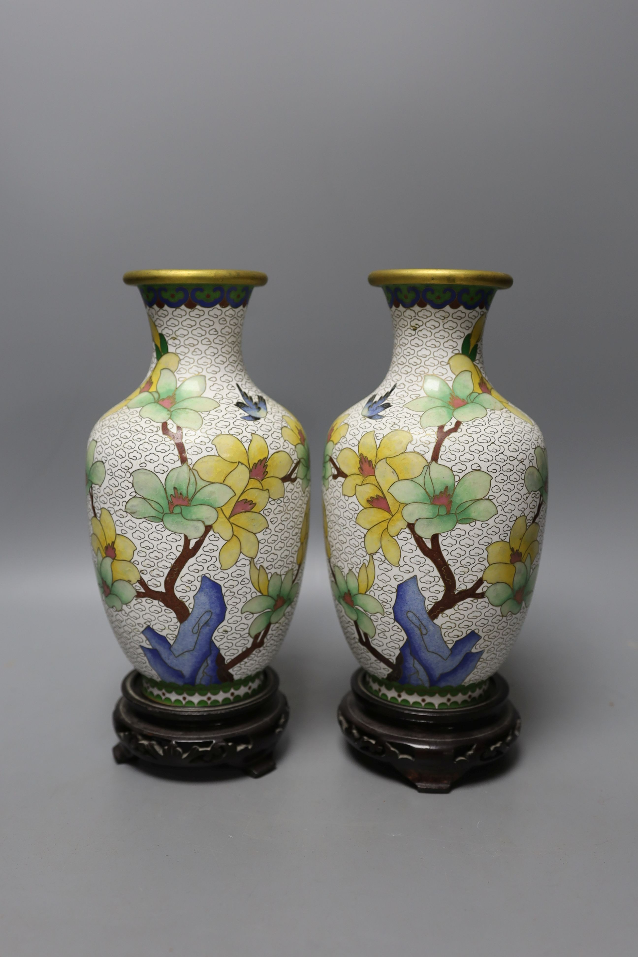 A pair of Chinese cloisonné enamel vases, 25cm tall including stands, together with a Chinese cloisonné enamel dragon bowl (3)